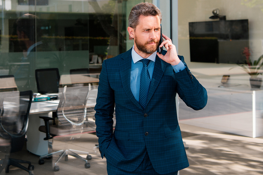 Businessman on a phone call outside an office building