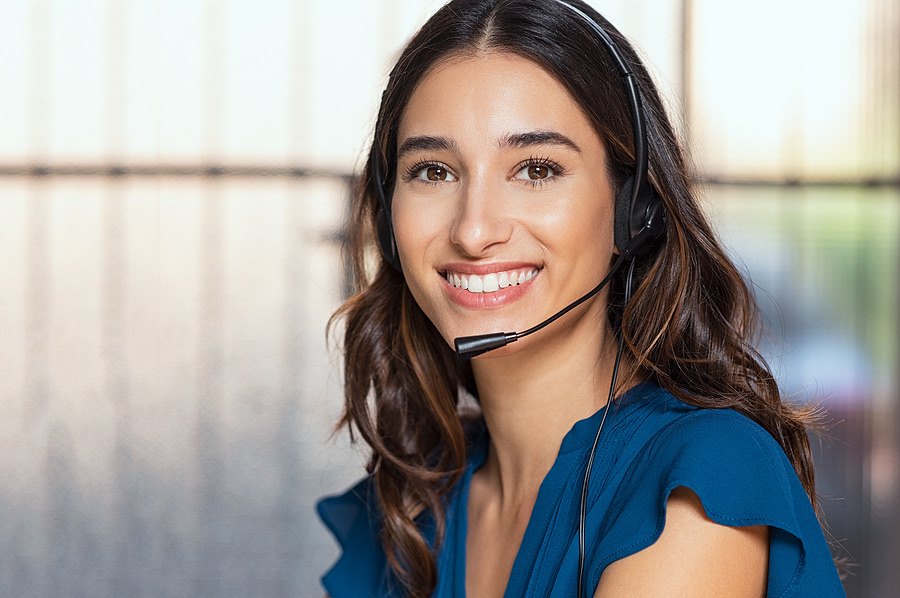 Smiling customer support agent wearing a headset