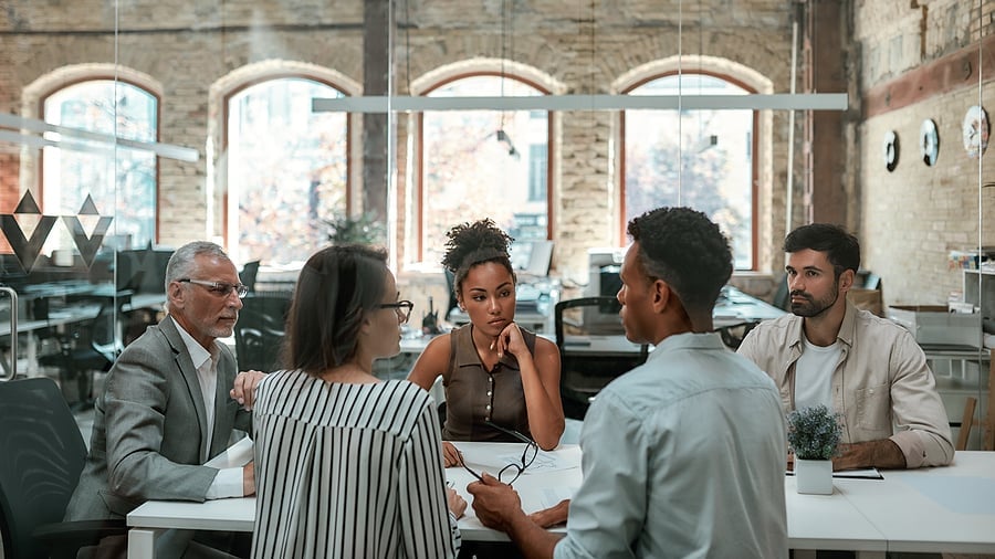 Colleagues gathered for a discussion in an office meeting