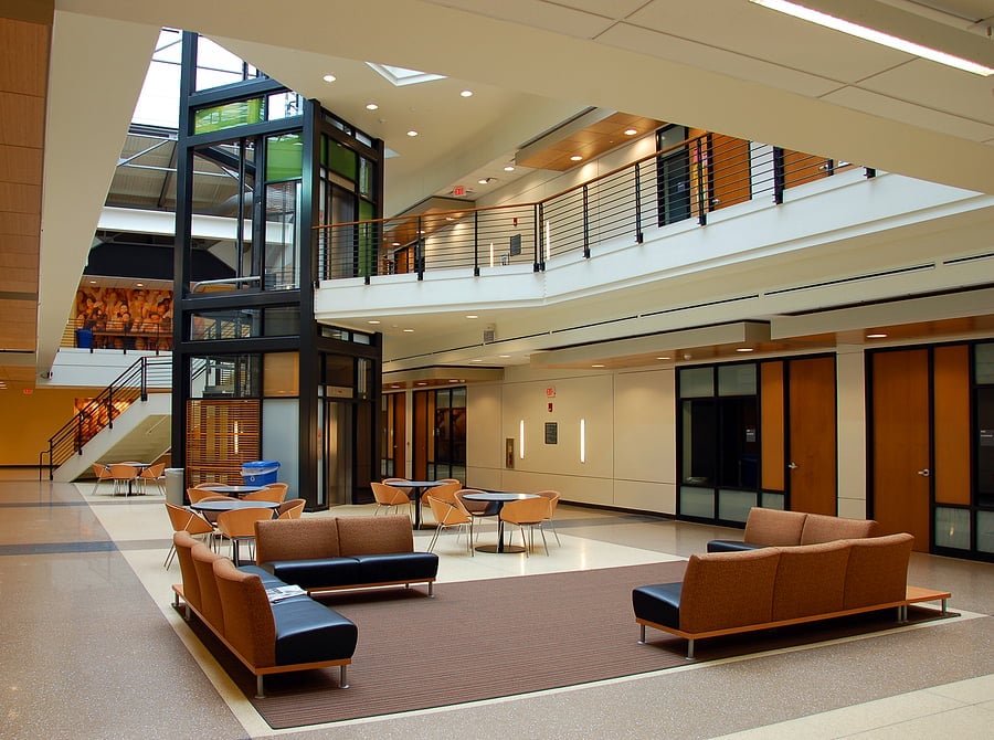 Modern office building atrium with seating areas and skylights