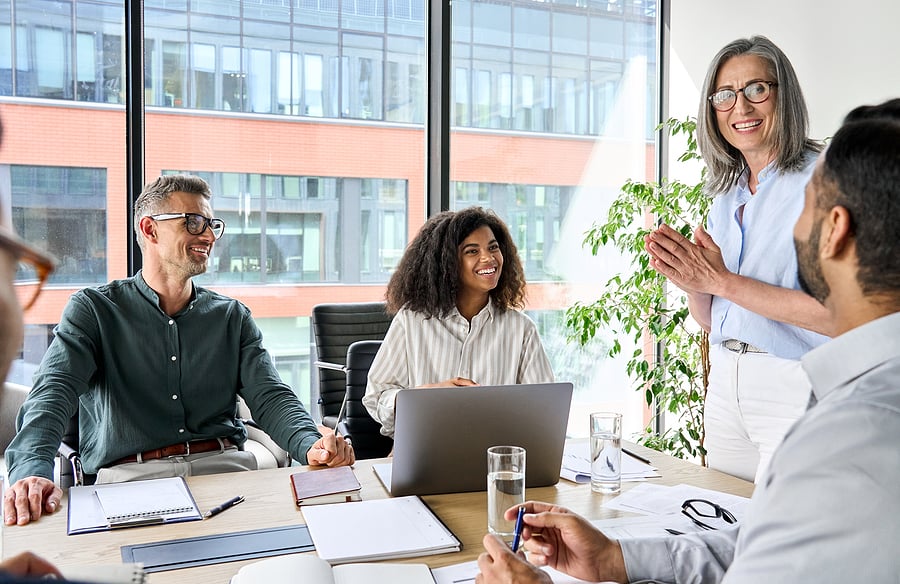 Executive leading a discussion with colleagues around a table