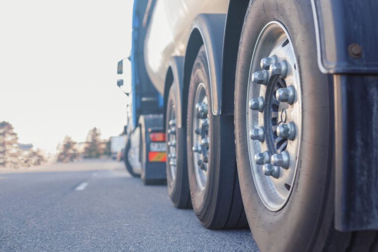 Semi-truck wheels on a highway — transportation business