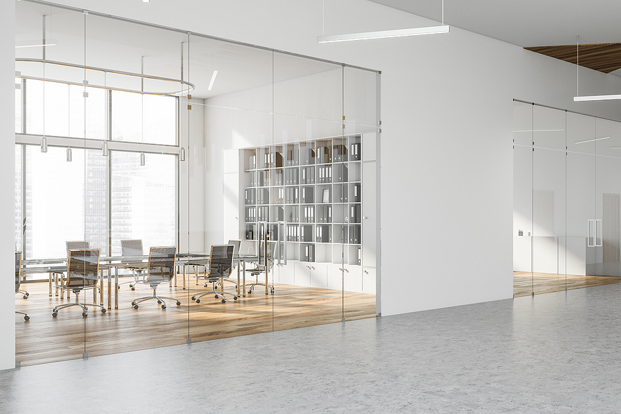 Empty modern conference room with glass walls and bookshelves