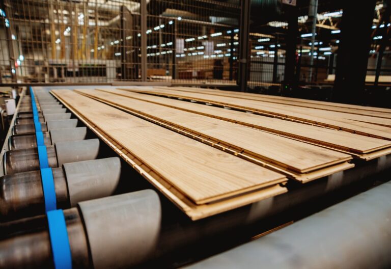 Hardwood flooring planks moving along a factory conveyor