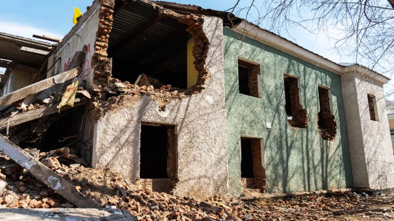 Storm-damaged two-story building with a collapsed wall